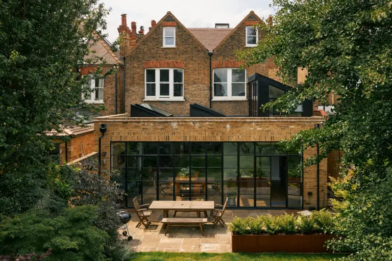 Private residence in Kew. External view of kitchen and dining room extension with bespoke conservation plateau rooflights to create a sawtooth natural lighting effect
