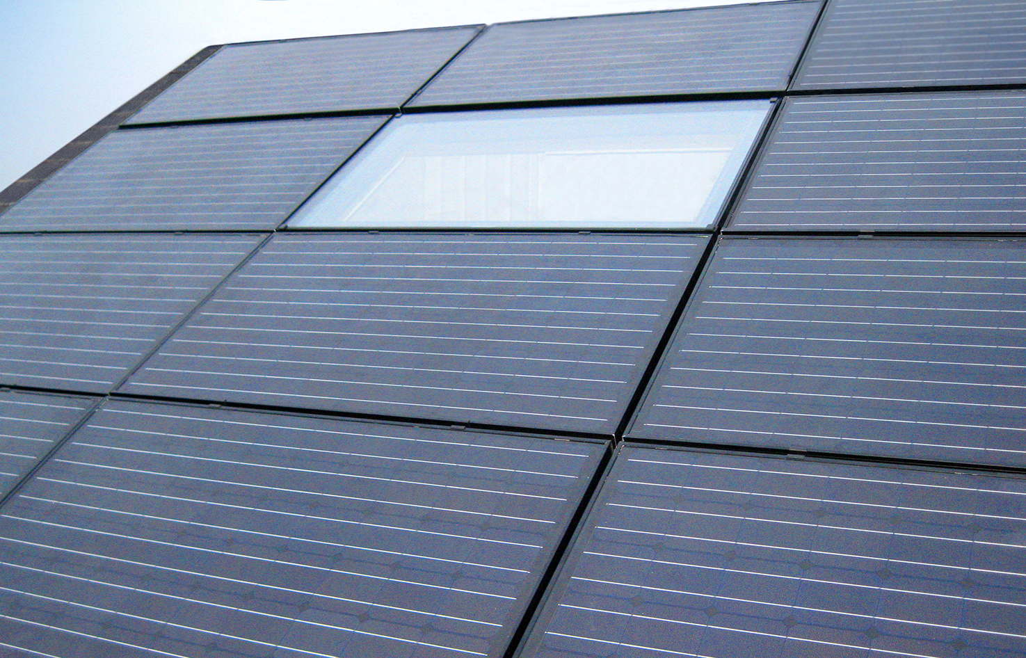 Rooflight surrounded by solar panels - Teddington House. Contractor Hub: Solutions