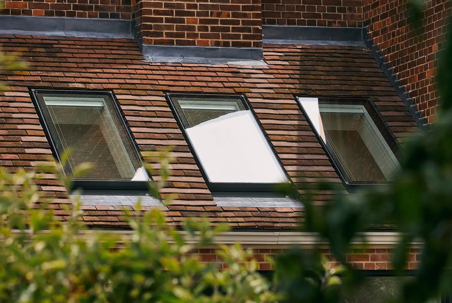 External view of three neo rooflights installed in a tiled roof. Helpful Guides - Do rooflights need planning permission?