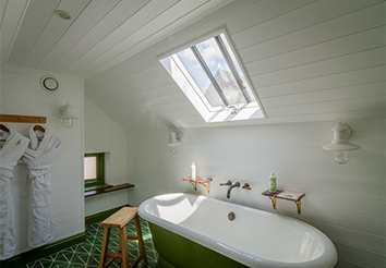 Internal View of one of the Bathrooms at Double Red Duke, Clanfield, with a Conservation Rooflight installed above the bath